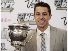 Johnny Gaudreau of the Calgary Flames poses with the Lady Byng Memorial Trophy after winning the honor during the NHL Awards, Wednesday, June 21, 2017, in Las Vegas.