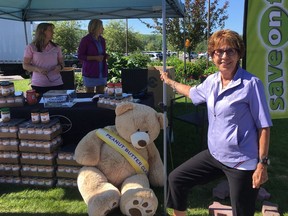 Heather Forsyth, president and founder of the Peanut Butter Classic women's charity golf tournament, with some of the donations for the Calgary Food Bank. The event raised $160,000 for Alcove, a women's addictions recovery centre.