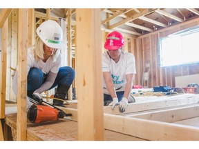 Serena Hiscock and Mary Thymaras of Excel Homes work on one of the fourplexes being contructed through the Women Build event through Habitat for Humanity Southern Alberta.