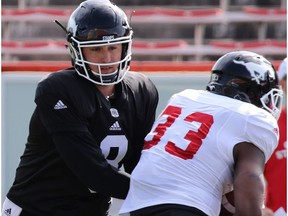 Calgary Stampeders quarterback  Mitchell Gale hands off to running back Jerome Messam during training camp at McMahon Stadium in Calgary on Monday May 29, 2017.