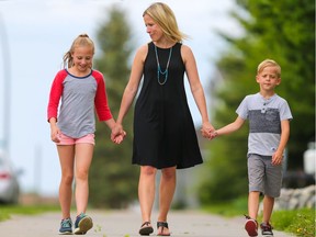 Melissa Sawers with two of her three children Jude and Chloe in Chaparral. Jude will be alone on a yellow bus and Chloe and her older sister will have to take two buses and a CTrain, a 70 minute commute, to get to and from school everyday.