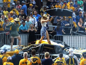 NASHVILLE, TN - JUNE 03:  A Nashville Predators fan hits a Pittsburgh Penguins car with a sledgehammer prior to Game Three of the 2017 NHL Stanley Cup Final between the Pittsburgh Penguins and the Nashville Predators at the Bridgestone Arena on June 3, 2017 in Nashville, Tennessee.  (Photo by Bruce Bennett/Getty Images)