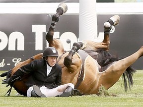 Elizabeth Gingras gets tossed during Spruce Meadows' National on Wednesday.