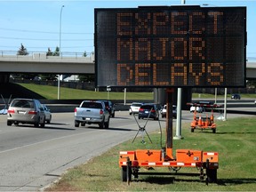 A sign warns of impending delays on Glenmore Trail.