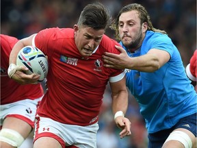 Canada's wing DTH van der Merwe (C) is tackled by Italy's lock Josh Furno (R)  during a Pool D match of the 2015 Rugby World Cup between Italy and Canada at Elland Road in Leeds, north England, on September 26, 2015.