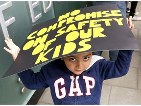Sameep Chatha,2, and his parents were among 50 protesters who rallied to protest a CBE decision to stop yellow bus service and bell changes at the Calgary Board of Education office June 13, 2017.