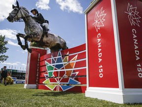 Bezzie Madden, of the United States, riding Con Taggio, competes in the National show jumping competition at Spruce Meadows in Calgary on June 11, 2017.