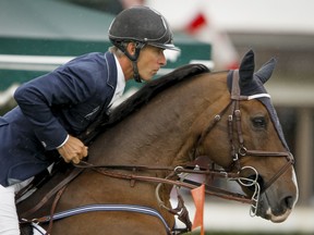Richard Spooner of the U.S.A. rides Cristallo in Phase 1 of the Tourmaline Oil Cup during the Masters tournament at Spruce Meadows in Calgary, Alta., on Friday, Sept. 12, 2014. The Masters is the show-jumping facility's annual signature event. Lyle Aspinall/Calgary Sun/QMI Agency