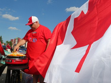 Tony Tiberio grills pre game dinner outside McMahon Stadium before the team's home opener against the Ottawa Redblacks on June 29, 2017.  Gavin Young/Postmedia Network