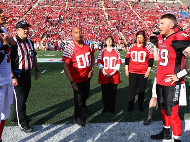 Family of  the late, great Stampeders legend Sugarfoot Anderson ,who passed away in March at the age of 97, take part in the coin toss before the Calgary Stampeders CFL season opener against the Ottawa Redblacks at McMahon Stadium in Calgary. AL CHAREST/POSTMEDIA