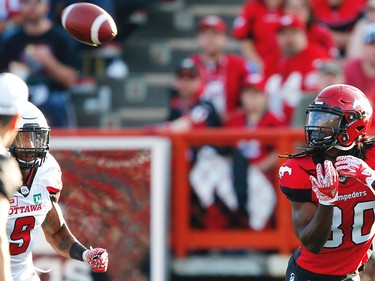 Calgary Stampeders Marken Michel with touchdown catch against Jonathan Rose of the Ottawa Redblacks during CFL football in Calgary. AL CHAREST/POSTMEDIA