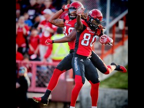 Calgary Stampeders Marken Michel celebrates after his touchdown against the Ottawa Redblacks with teammate Kamar Jorden during CFL football in Calgary. AL CHAREST/POSTMEDIA