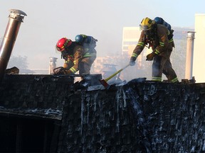 Fire crews battle the two-alarm blaze at 16th Street and 15th Avenue S.W. in Sunalta Monday.