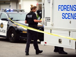 The Calgary police forensic unit on scene after an incident at 83 Panamount Common in NW Calgary, Alta., on June 10, 2017.