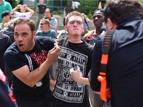 Two counter protestors confront supporters of an anti-Islam rally at Calgary city hall in Calgary, on Saturday,