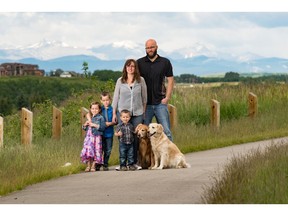 Meghan and Mat Ward with their children Hunter, Peyton and Lincoln, and dogs Asha and Kaia in MountainView by Apex Land in Okotoks.