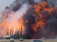 A giant fireball is visible as a wildfire rips through the forest by Highway 63, 16 kilometres south of Fort McMurray, Alta on May 7, 2016. THE CANADIAN PRESS/Jonathan Hayward