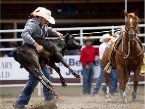 Cade Swor of Winnie, Texas during tie-down roping at the Calgary Stampede on Saturday July 8, 2017.