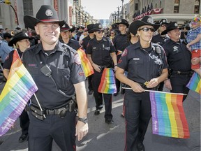 The Calgary Police Service flies its colours in the Pride Parade in downtown Calgary, Alta., on Sunday, Aug. 31, 2014.