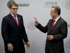 Mexico&#039;s Secretary of Energy Pedro Joaquin Coldwell, right, talks to his U.S. counterpart Rick Perry, after making a joint statement in Mexico City, Thursday, July 13, 2017. (AP Photo/Eduardo Verdugo)