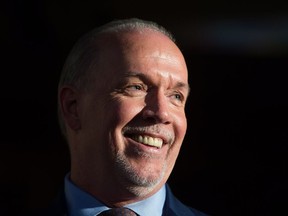 British Columbia Premier-designate, NDP Leader John Horgan smiles while speaking outside Government House after meeting with Lt-Gov. Judith Guichon in Victoria, B.C., on Thursday, June 29, 2017. THE CANADIAN PRESS/Darryl Dyck ORG XMIT: VCRD133