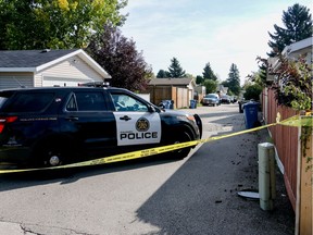 Calgary police and investigators at the scene where a body was found in an alley along 41A Ave SE  in Calgary on Thursday September 1, 2016.