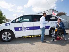 Lauri Brunner, right, Chair of Calgary's Advisory Committee on Accessibility discusses the merits of the new City Calgary Cab service with a driver in front of one of the fleets vehicles Sunday July 2nd, 2017.