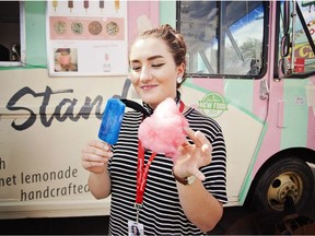 Postmedia reporter Alanna Smith tries the Troll Pop from the Cookie Dough Stand outside the Big Four Building at the Calgary Stampede on Saturday, July 8, 2017.