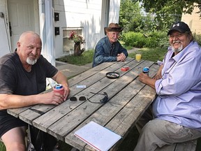 Carl Larson (left) and his friends Willard (centre) and JR pop cold mid-afternoon beers at a picnic table behind JR's house. The friends live close to the Stampede grounds and shared their thoughts on being such close neighbours to the Greatest Outdoor Show on Earth. For Stampede story by Bill Kaufmann. BILL KAUFMANN/POSTMEDIA

Postmedia Calgary Stampede2017
Bill Kaufmann