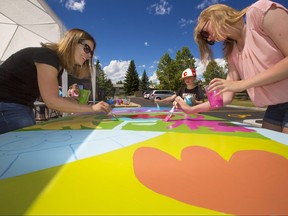 Dozen of Silver Springs Community members gathered to help artist Dean Stanton paint 24 panels which will form a mural on the newly renovated Silvers Springs pool building. The painting began on Sunday July 23, 2017 and will continue on Monday and Tuesday. Gavin Young/Postmedia