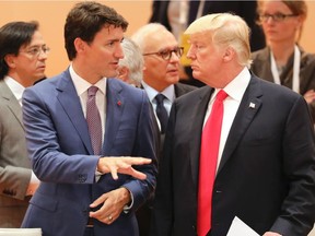 U.S. President Donald Trump talks with Prime Minister Justin Trudeau at the beginning of the third working session of the G20 meeting in Hamburg, northern Germany, on July 8.