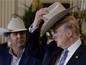 US-POLITICS-TRUMP-MADE IN AMERICA

President Donald Trump examines US-made products from all 50 states, including a Stetson brand hat, beside Dustin Noblitt (L), President and Chief Operating Officer, in the East Room of the White House in Washington, DC, on July 17, 2017.   / AFP PHOTO / Olivier DoulieryOLIVIER DOULIERY/AFP/Getty Images
OLIVIER DOULIERY, AFP/Getty Images