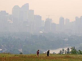 Joggers run through Edworthy Park as forest fire smoke causes air quality to deteriorate.