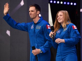 Canada's newest astronauts Joshua Kutryk and Jennifer Sidey acknowledge the crowd during Canada 150 celebrations on Parliament Hill in Ottawa on Saturday, July 1, 2017. THE CANADIAN PRESS/ Sean Kilpatrick