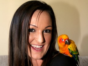 Breanna Markel, and her parrot Bob pose for a photo after being reunited. Bob had been missing since May 1, 2017 and was found three months later by a woman living near Spruce meadows, over 15kms away.Wednesday, July 26, 2017. Dean Pilling/Postmedia