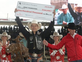 2017 Calgary Stampede saddle bronc champion Zeke Thurston from Big Valley, AB, is presented with a cheque for $100,000 after winning the final day at the Stampede Rodeo. Sunday July 16, 2017 in Calgary