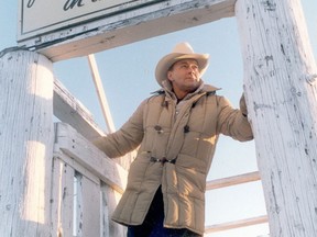 Former Stampede Rodeo manager Winston Bruce takes a break in the chutes where the horses romp at the Stampede Ranch in 1988.