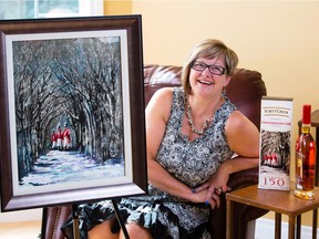 Calgary Artist Sheila Schaetzle poses in her home with her painting that is featured on a limited-edition, Canada 150 whisky from 40 Creek Whisky.