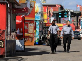Calgary Stampede security officers Lopez Sengi, left and Clark Saundh patrol the midway area at Stampede Park on Tuesday July 4, 2017.