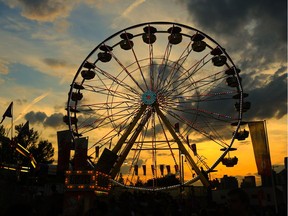 The sun sets behind the big ferris wheel on the Calgary Stampede midway, Wednesday July 12, 2017. GAVIN YOUNG/POSTMEDIA
Gavin Young, Gavin Young