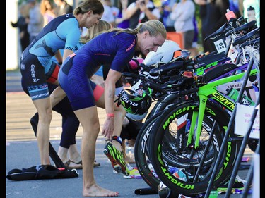 Women's pro athletes transition to their bikes during the Calgary Ironman 70.3 race on Sunday July 23, 2017.