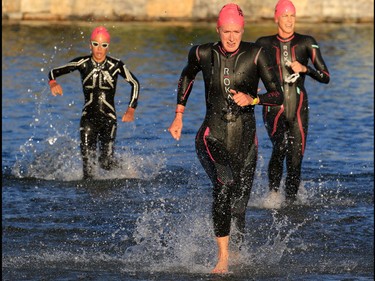 The second, third and fourth place pro woman race out of the water of Auburn Lake during the Calgary Ironman 70.3 race on Sunday July 23, 2017.