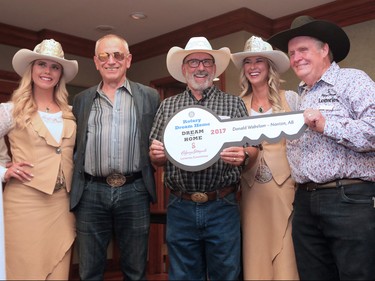 2017 Dream Home winner Donald Wakelam smiles with Homes by Avi's Avi Amir, left, Stampede Lotteries Chairman Lynn Grant and Stampede Queen Meagan Peters, and Princess Lizzie Ryman at the Stampede Lotteries reception at Stampede Park on Tuesday afternoon July 25, 2017.