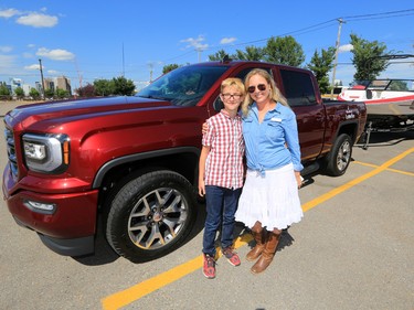 2017 Truck and Boat Stampede Lottery prize winner Amber Denton poses with her son Jacob before driving away on Tuesday afternoon July 25, 2017. All the lottery winners were hosted at a reception at Stampede Park.