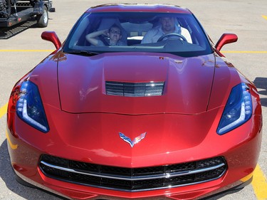 2017 Corvette Stampede Lottery prize winner Taylor Assen and his son test out their new car Tuesday afternoon July 25, 2017. All the lottery winners were hosted at a reception at Stampede Park.