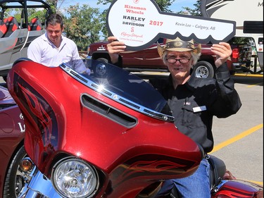 2017 Harley Davidson Prize winner in the Calgary Stampede Lotteries poses with his new bike on Tuesday afternoon July 25, 2017. All the lottery winners were hosted at a reception at Stampede Park.