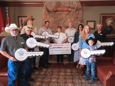 2017 Stampede Lotteries winners pose for a group photo at Stampede Park on Tuesday afternoon July 25, 2017.