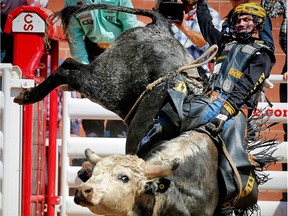 Montana cowboy Jess Lockwood rides Goose Bumps to a score of 87.50 in the bull riding event during the Calgary Stampede rodeo.