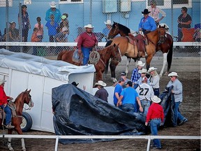 Roger Moore's wagon pulls up on the back stretch after finishing the race in heat 5 of the 2017 GMC Rangeland Derby at the Calgary Stampede. One of his horse was taken away in the horse ambulance. AL CHAREST/POSTMEDIA

Postmedia Calgary Stampede2017
Al Charest, Al Charest/Postmedia