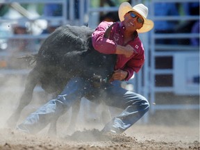 Donalda, Alberta bulldogger Cody Cassidy during the steer wrestling event at the Calgary Stampede rodeo.